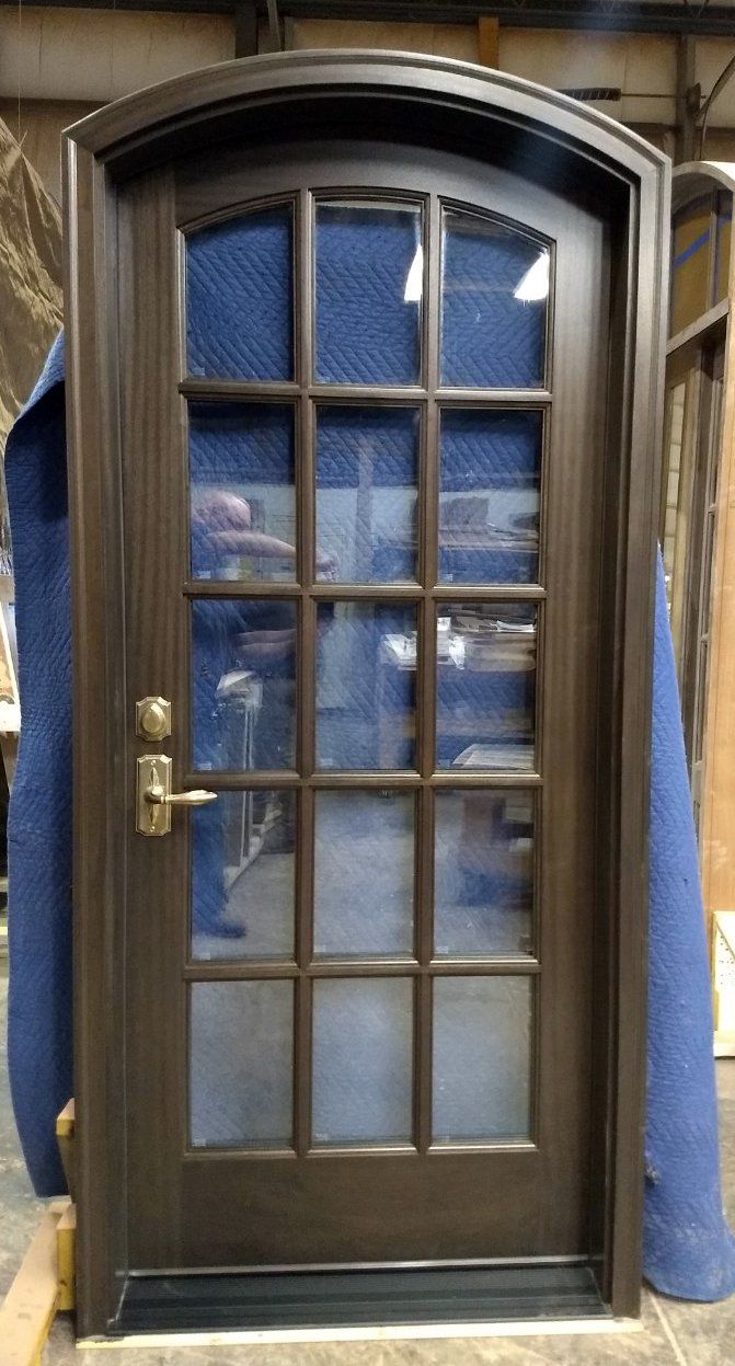 A door with a blue blanket covering it is sitting in a room.