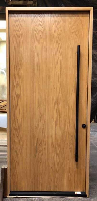 Vertical grain red oak stained honey Hoppe modern minimal multi-point lock with black hardware