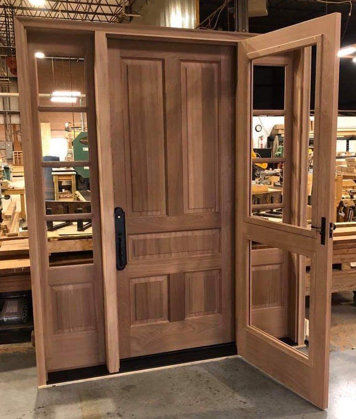 Mahogany exterior front door with matching sidelites and built-in storm door before factory finished