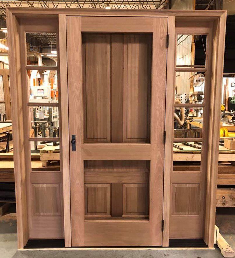 Mahogany exterior front door with matching sidelites and built-in storm door