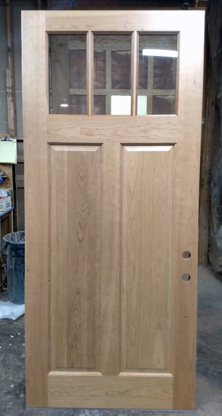 A wooden door is sitting on a table in a room.