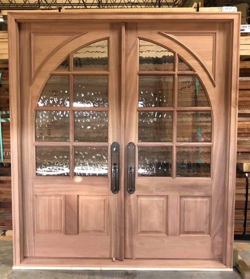 Mahogany double arched top panel exterior door in square frame