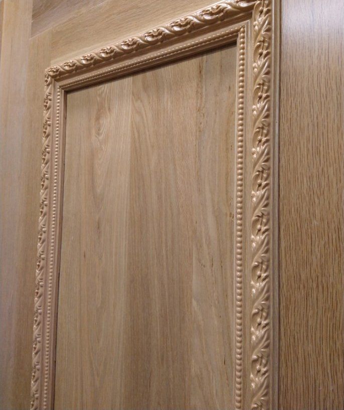 A close up of a wooden door with a wooden frame.