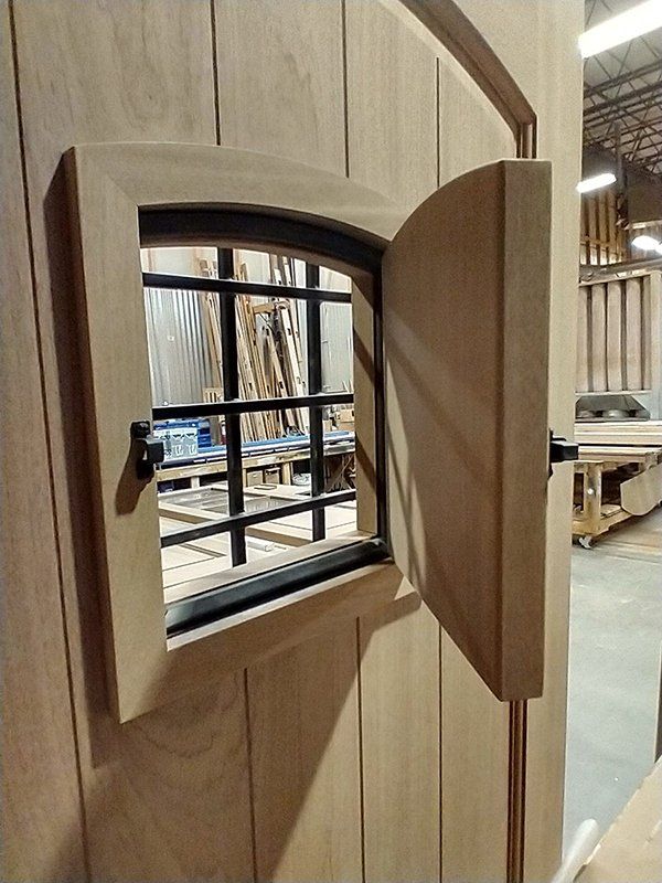 A wooden door with a small window in it