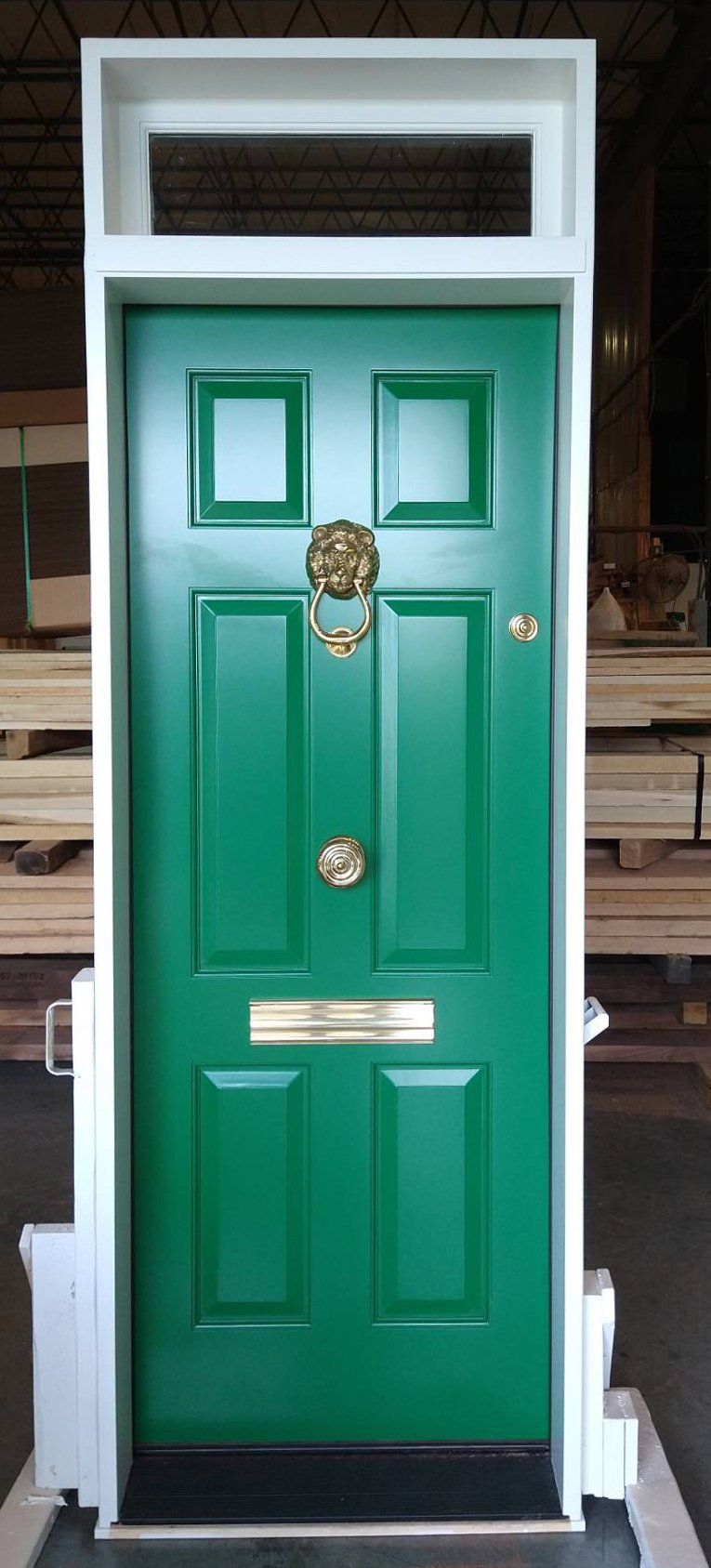 Painted 6 panel exterior door with transom fitted with mail slot and lion head knocker and French style lockset hardware