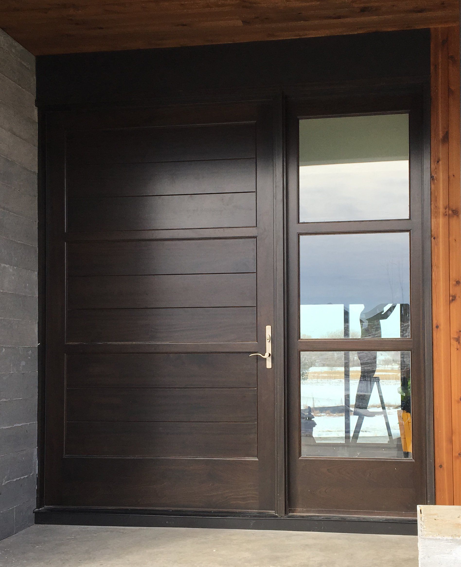 A large wooden door with a glass window
