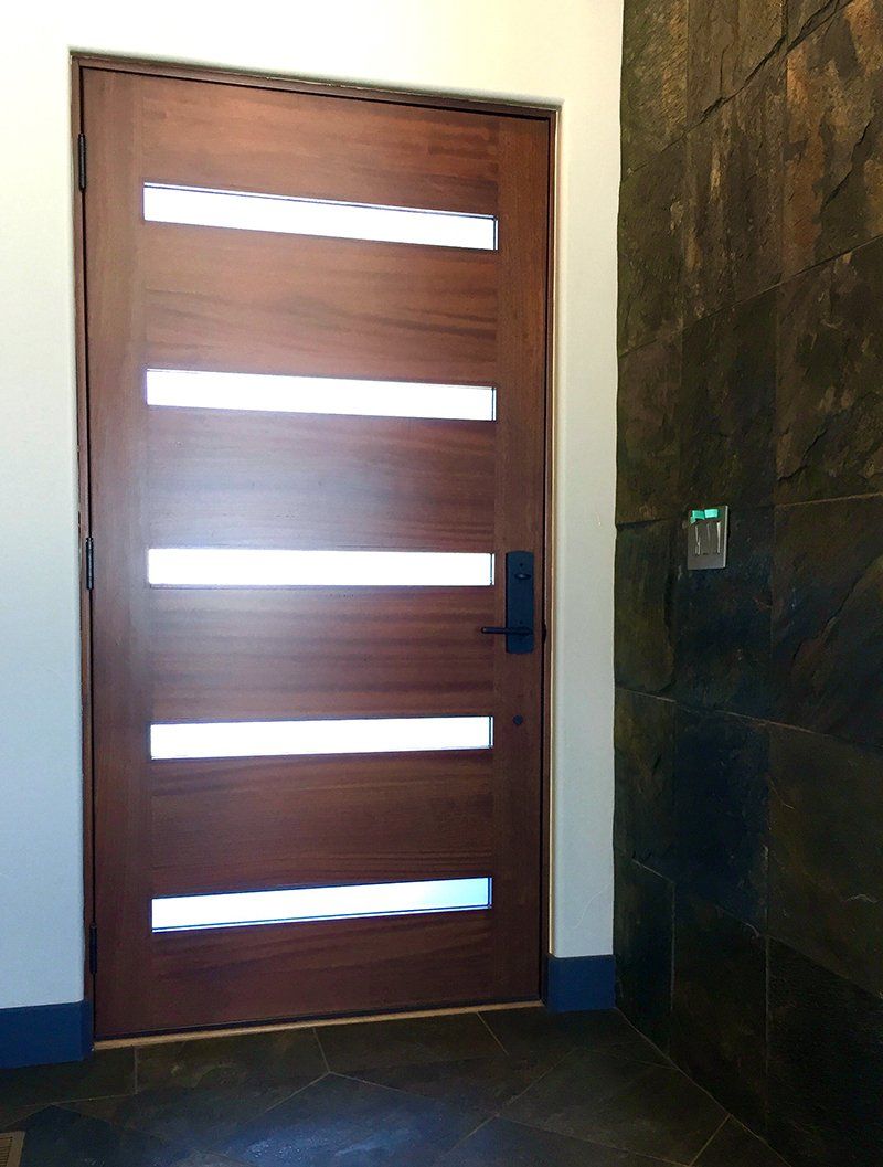 A wooden door with white stripes on it is in a room.