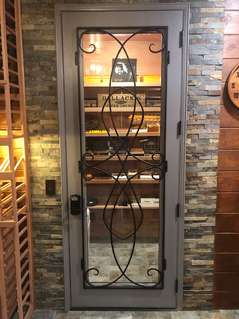 Custom mahogany interior door for private humidor features iron grille