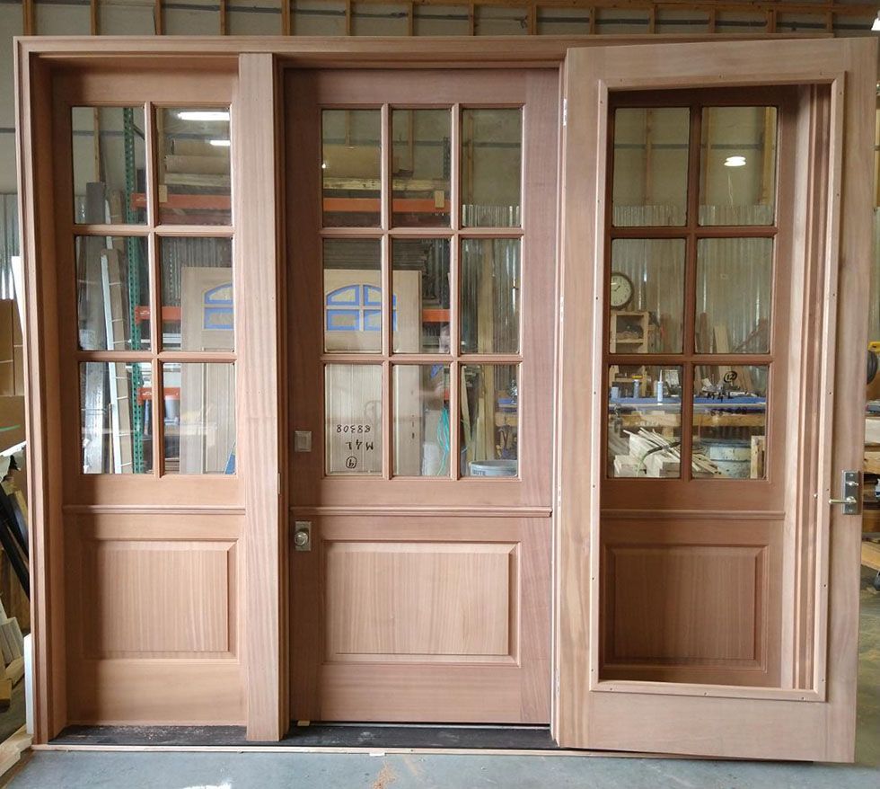 A set of wooden doors with glass panels in a room