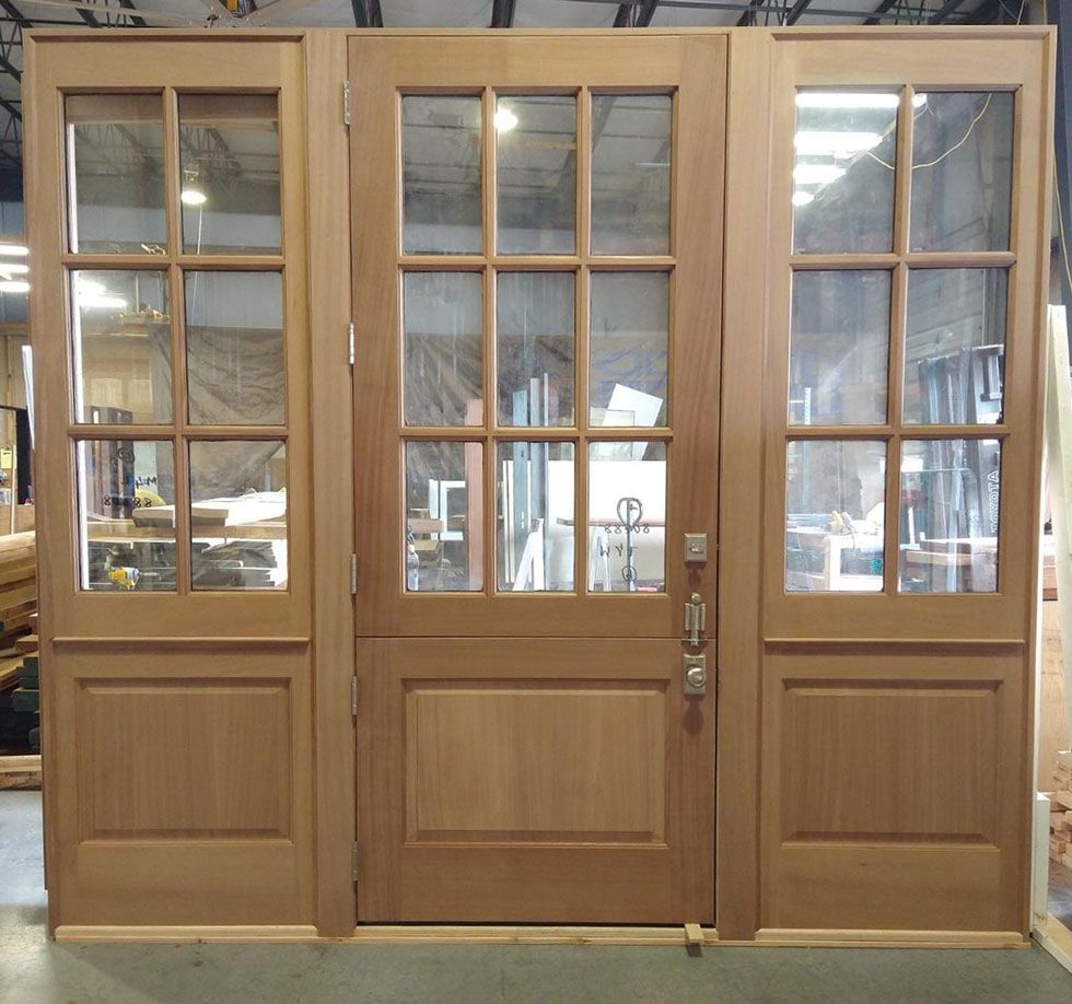 A set of three wooden doors with glass panels