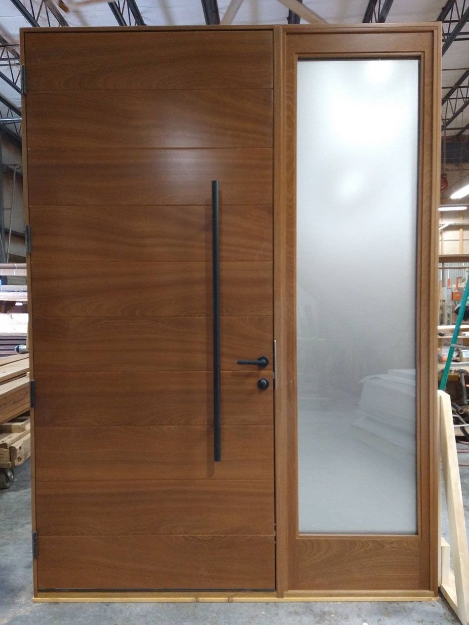 A large wooden door with a frosted glass window