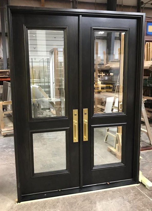 Walnut doors with beveled glass stained dark chocolate with installed Baldwin Evolve Bluetooth deadbolt..