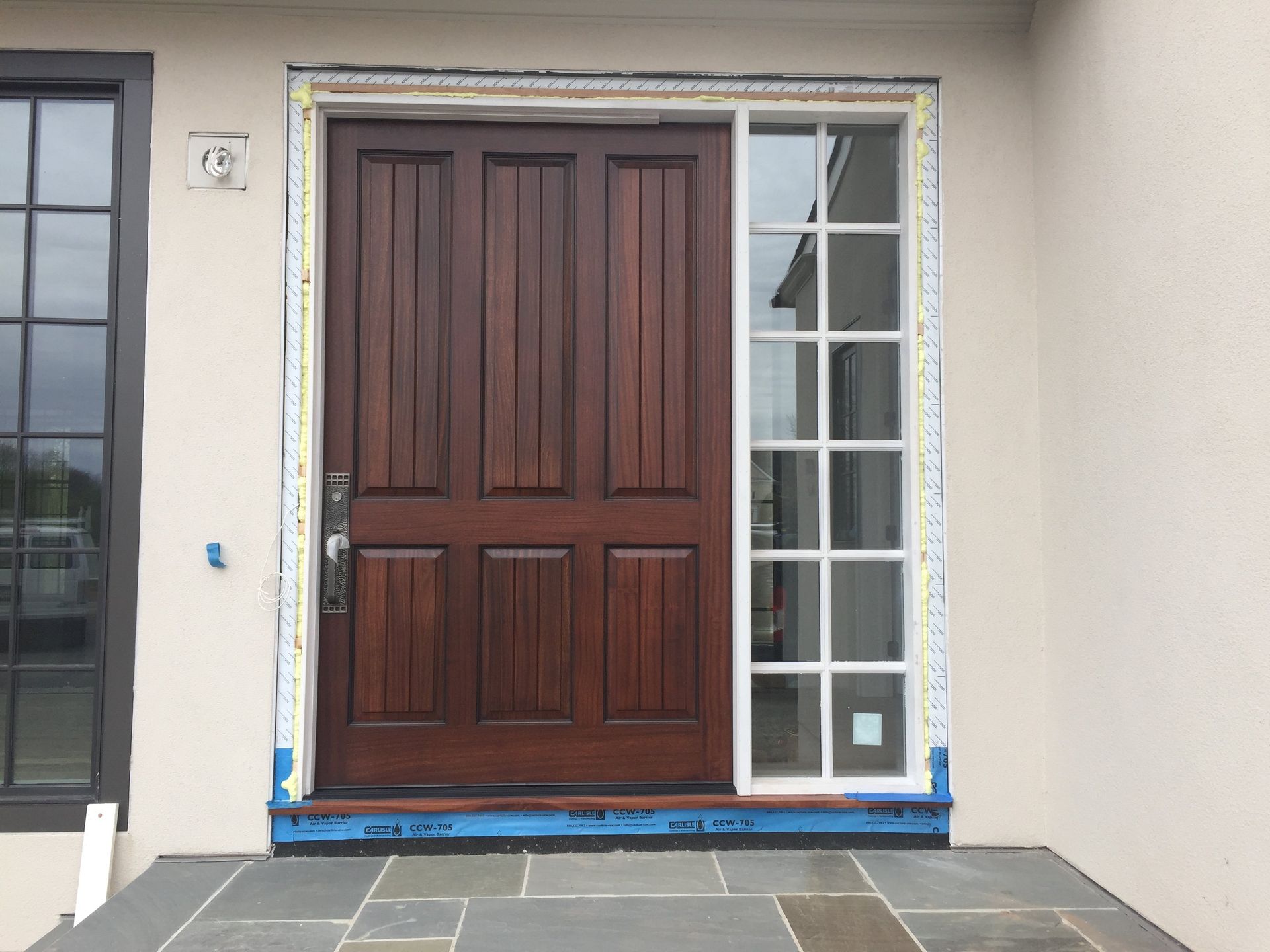 A wooden door with a window on the side of it