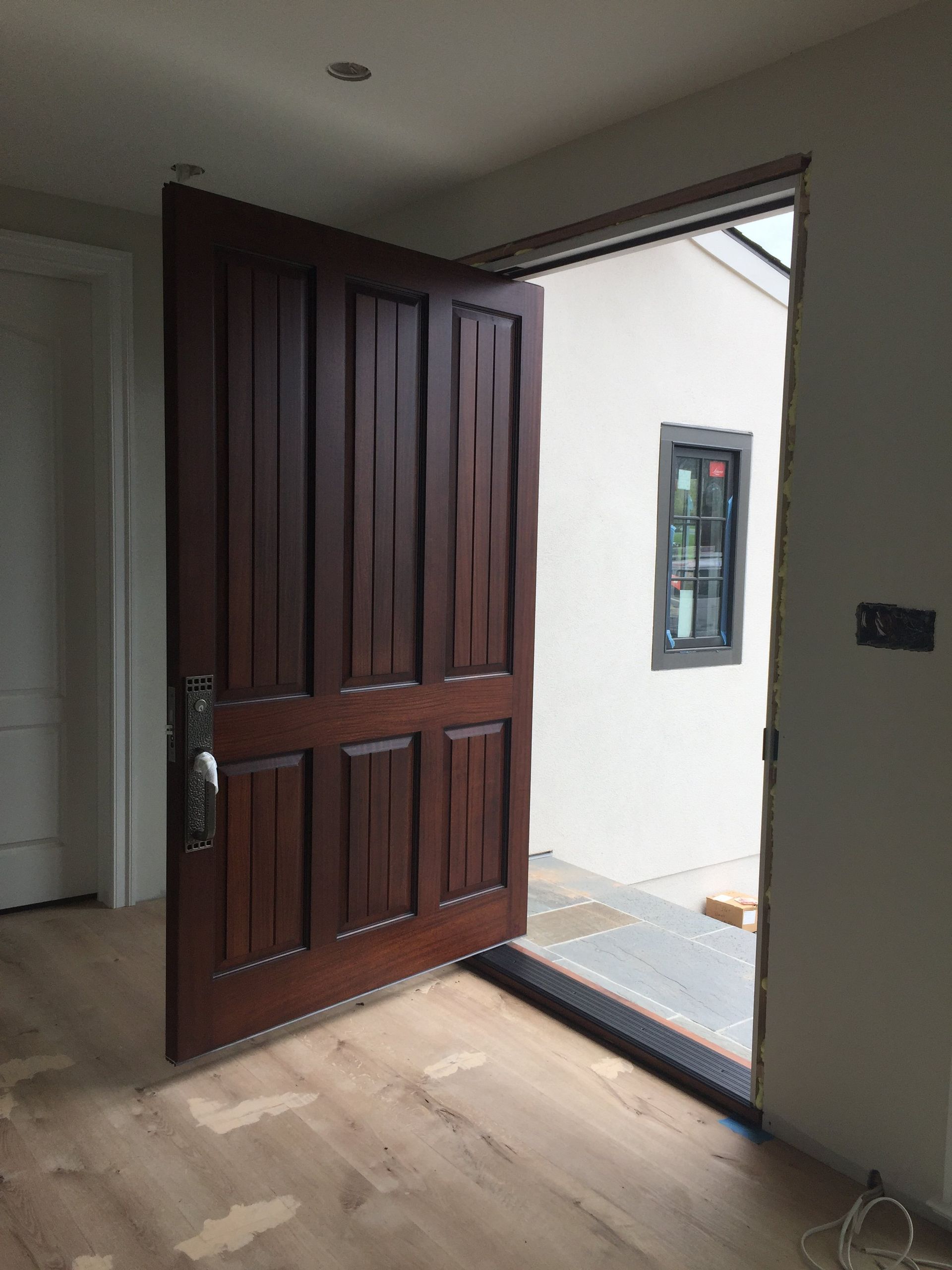 a wooden pivot door