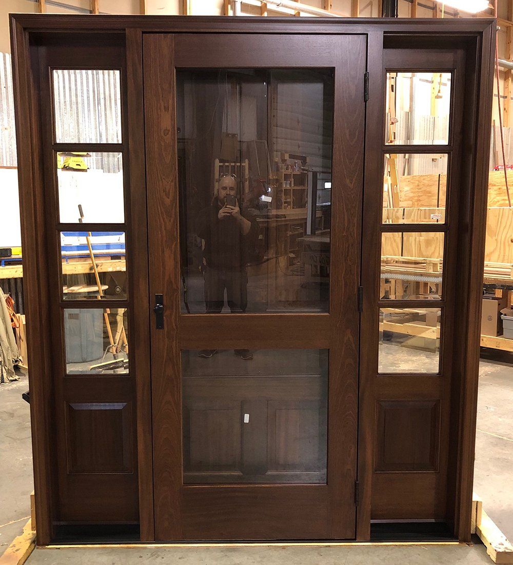 Mahogany exterior front door with matching sidelites and built-in storm door factory finished