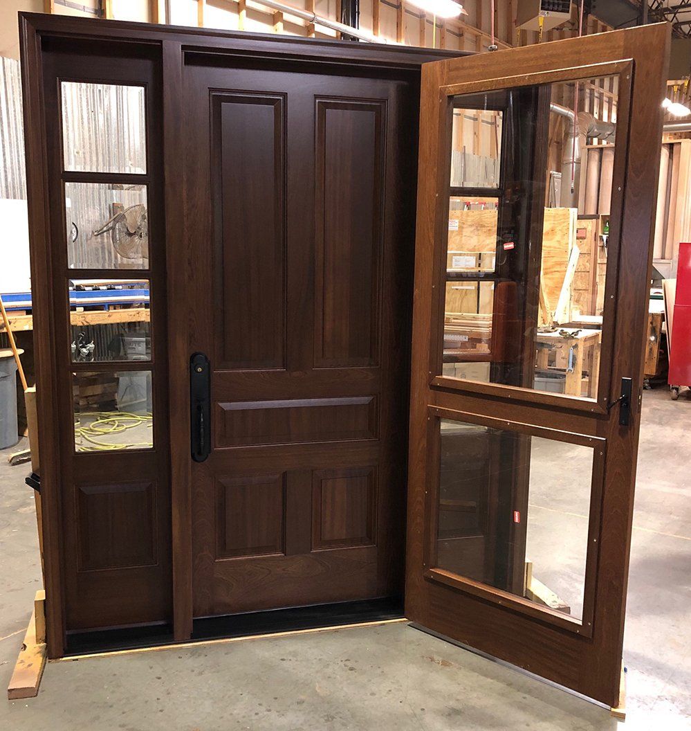 Mahogany exterior front door with matching sidelites and built-in storm door factory finished