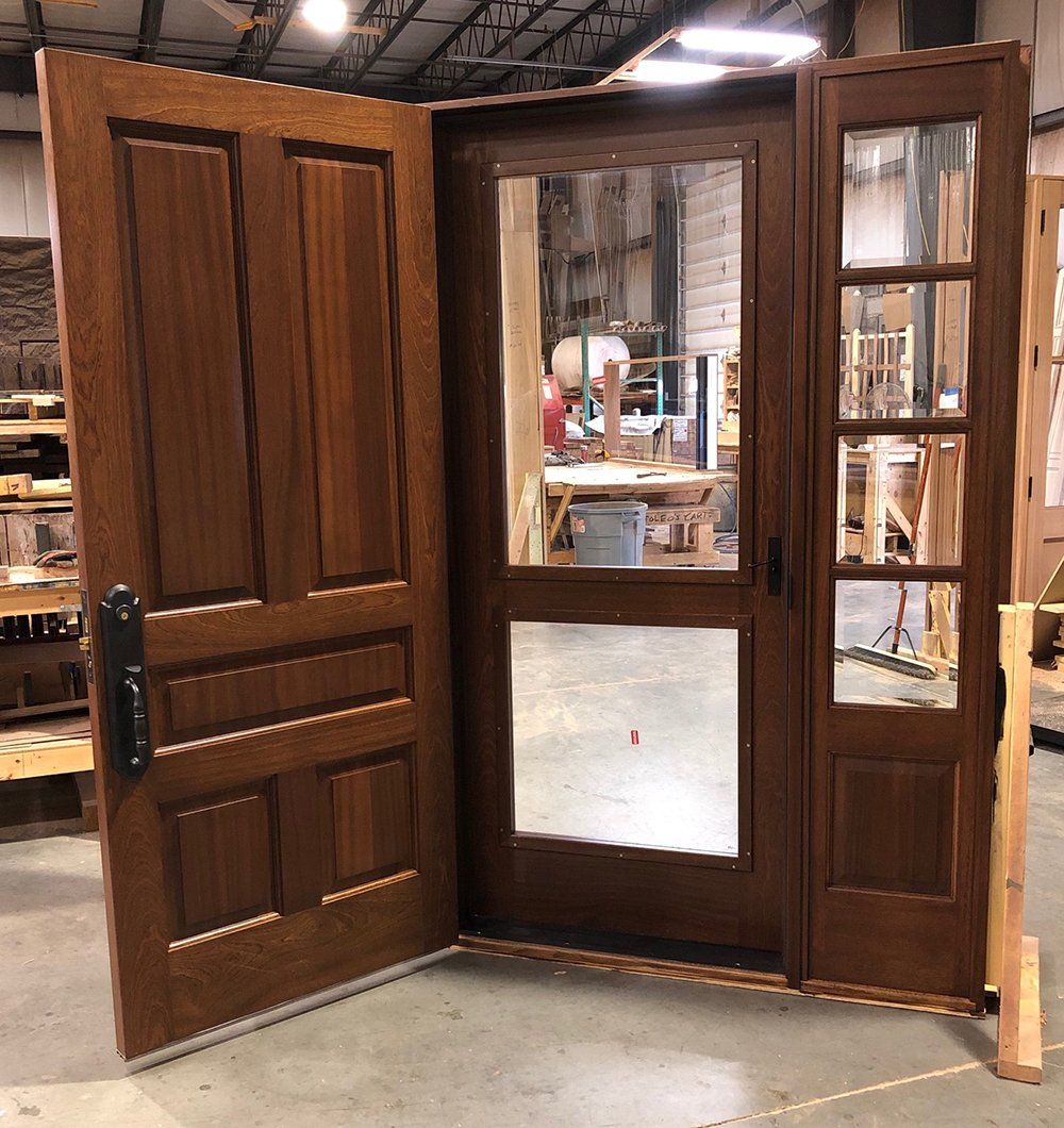 A pair of wooden doors are open in a warehouse