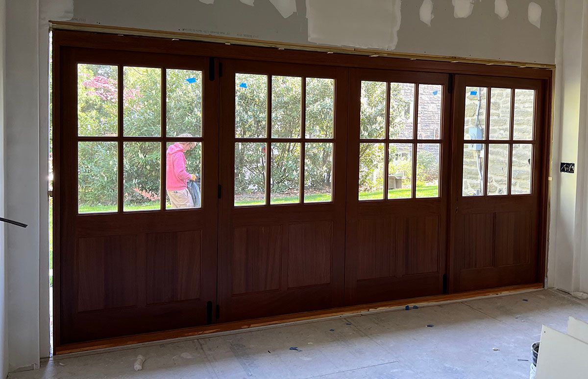 Curtis #28323 
Bifold Sapele Mahogany 15 foot wide door system
Stained Chapparal Interior