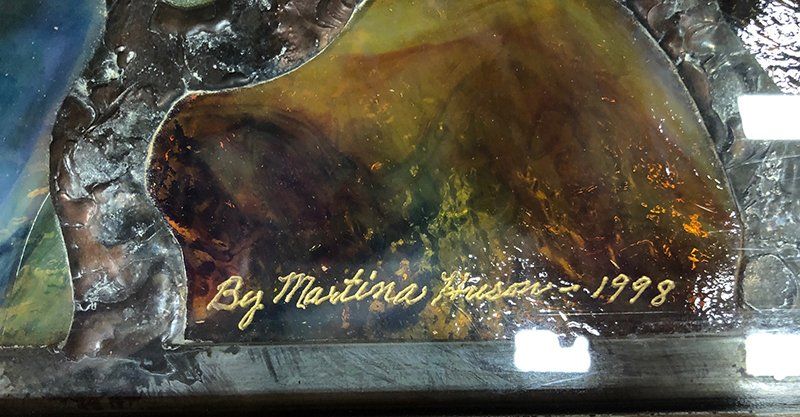 A close up of a painting with the year 1998 on it