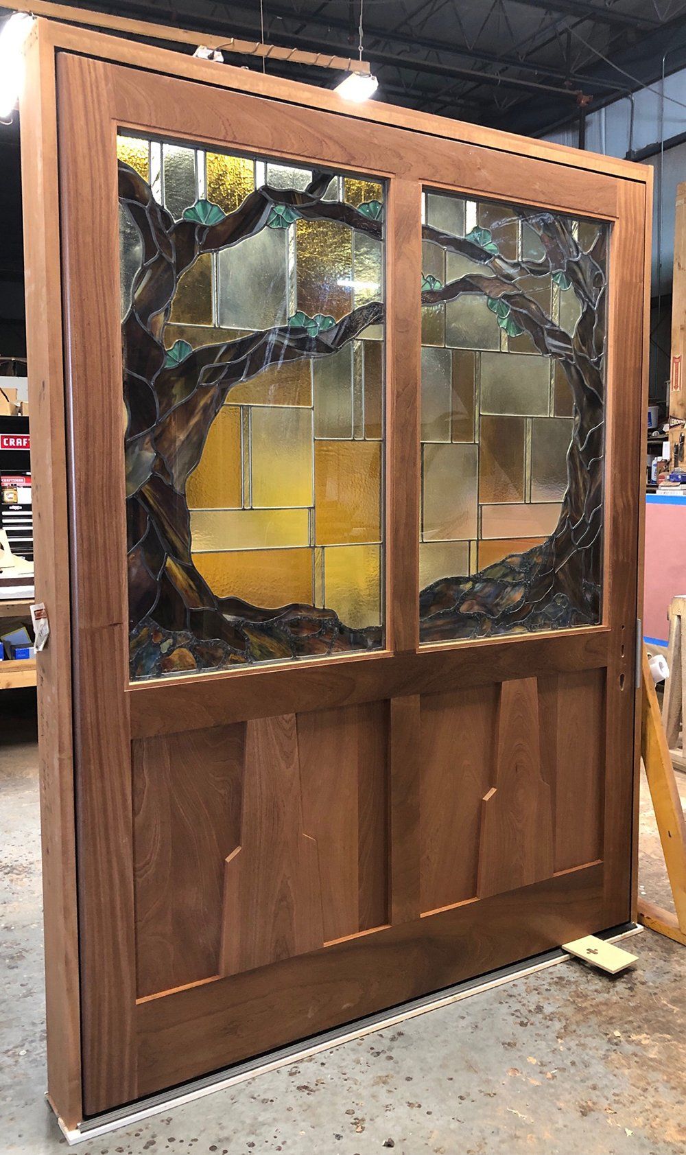 Entry door with custom glass insert. Stained differently on inside and outside.