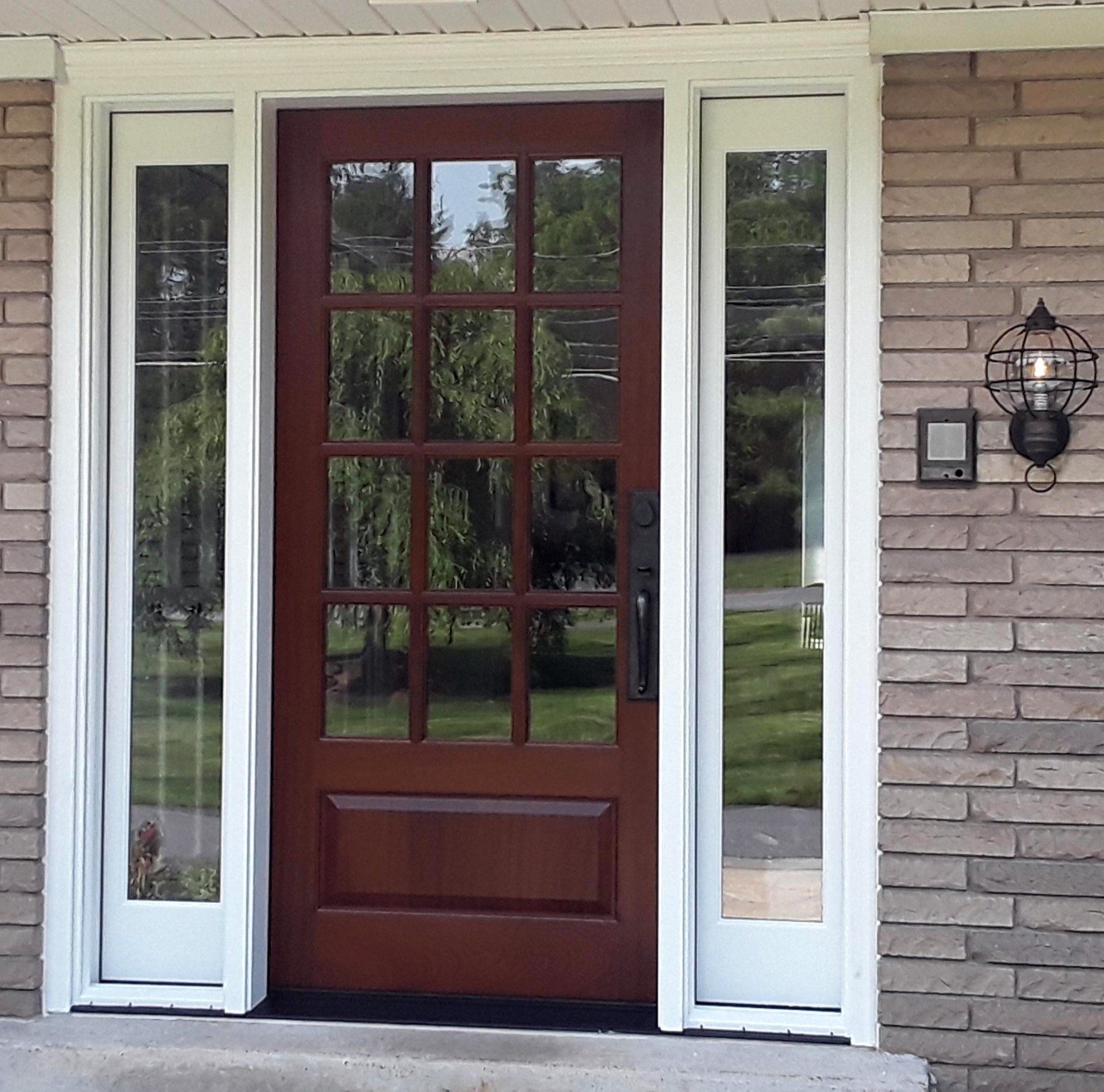 Mahogany door with operable sidelites Finished in saddle Exterior view