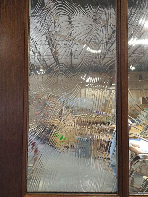A close up of a glass door with a pattern on it.