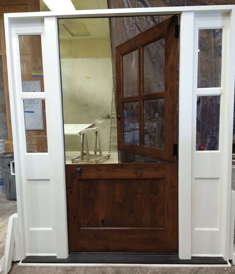 A wooden door with a white frame is open in a room.