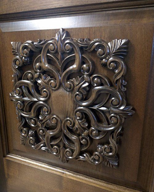 A wooden door with a carved design on it