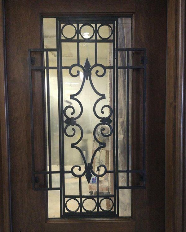 A door with a wrought iron design on it
