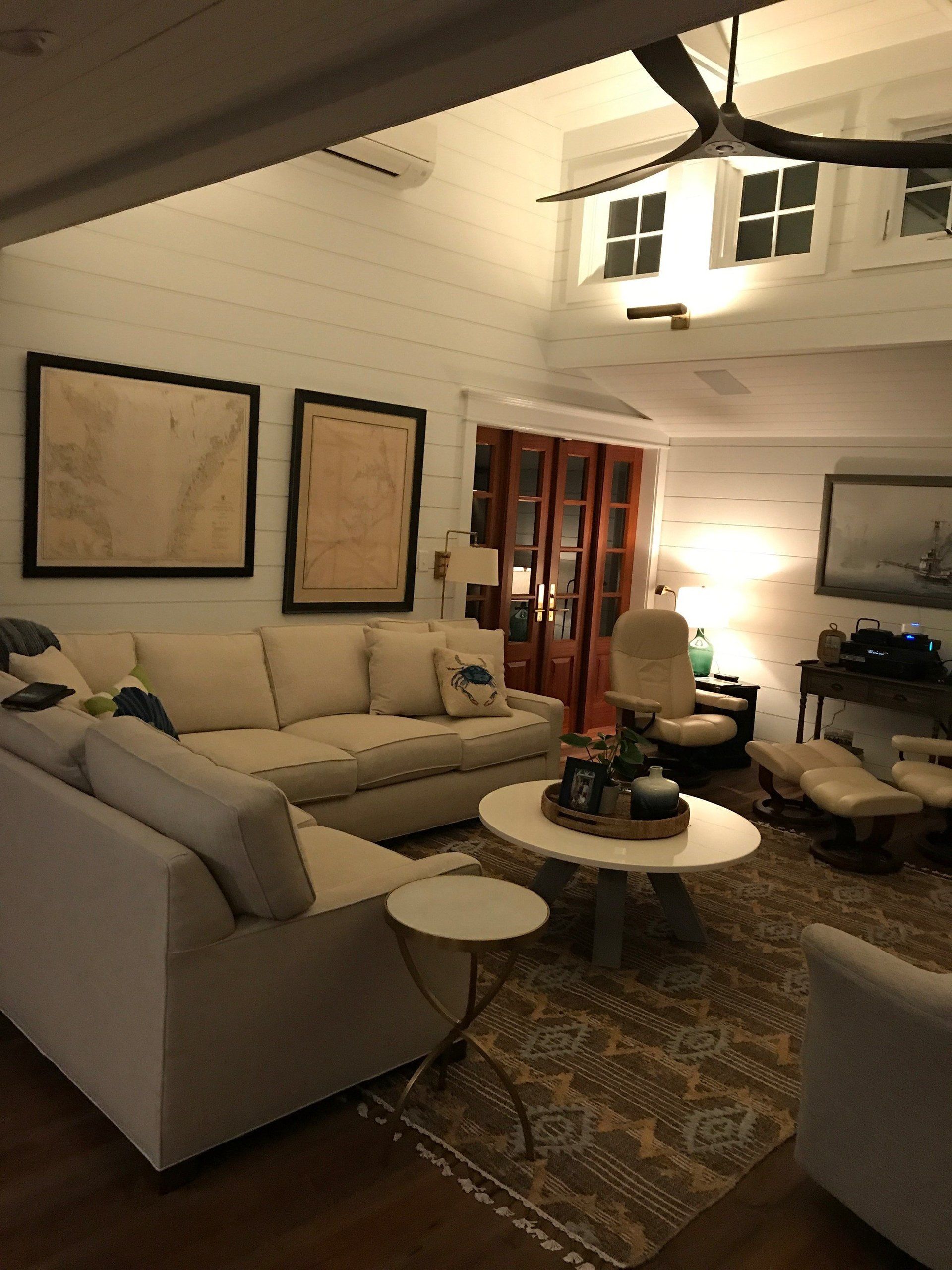 A living room filled with furniture and a ceiling fan