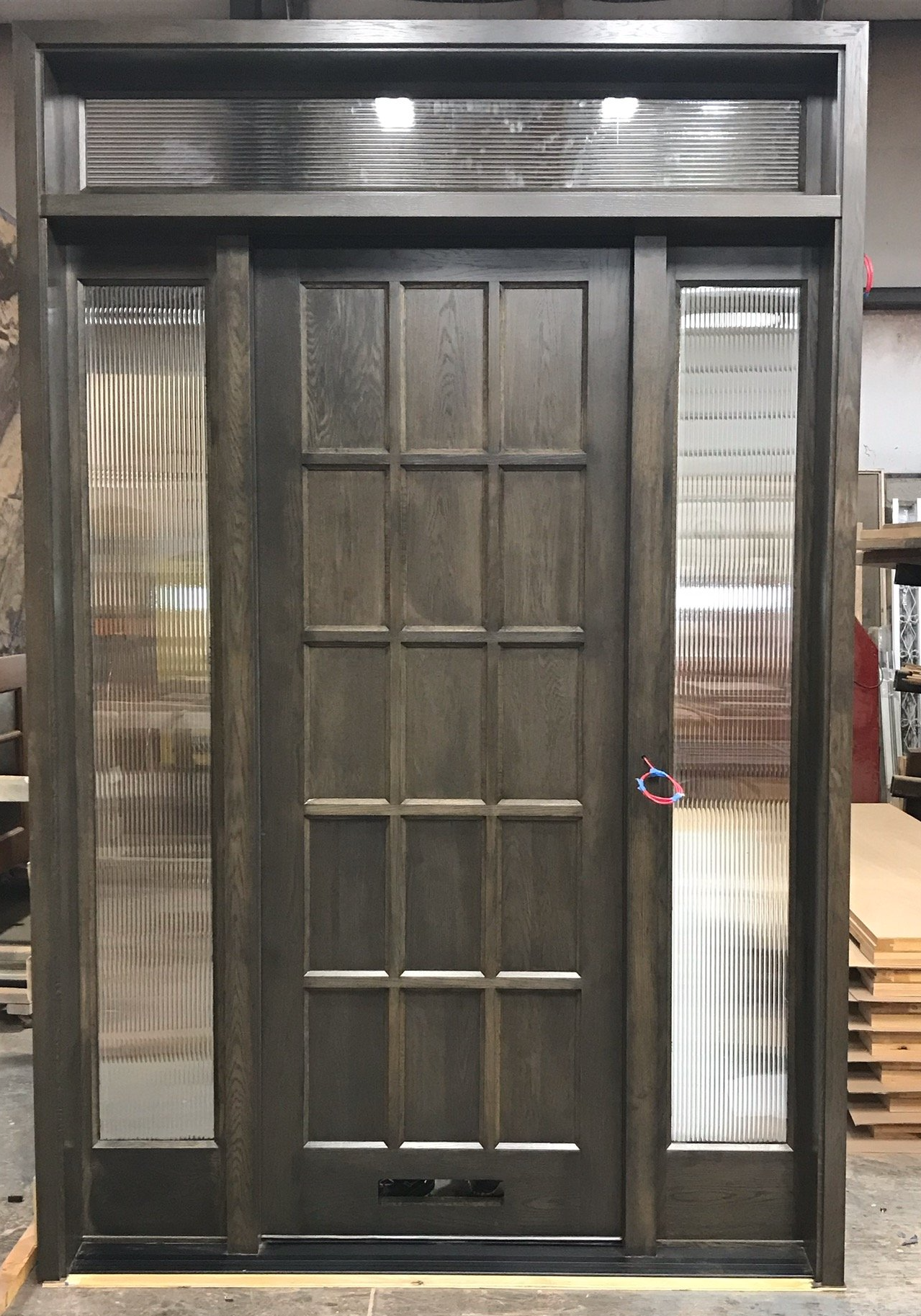 15 panel solid wood door with reeded glass side windows and transom
