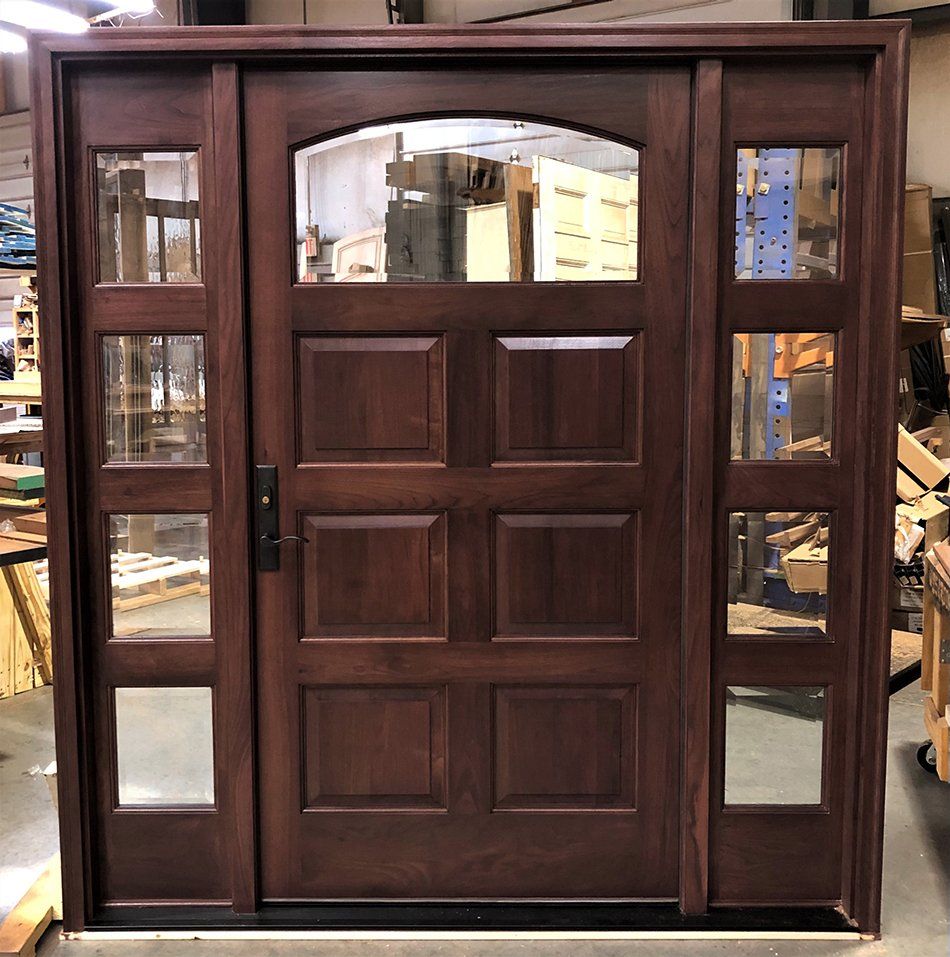 Walnut wood entry door with sidelites