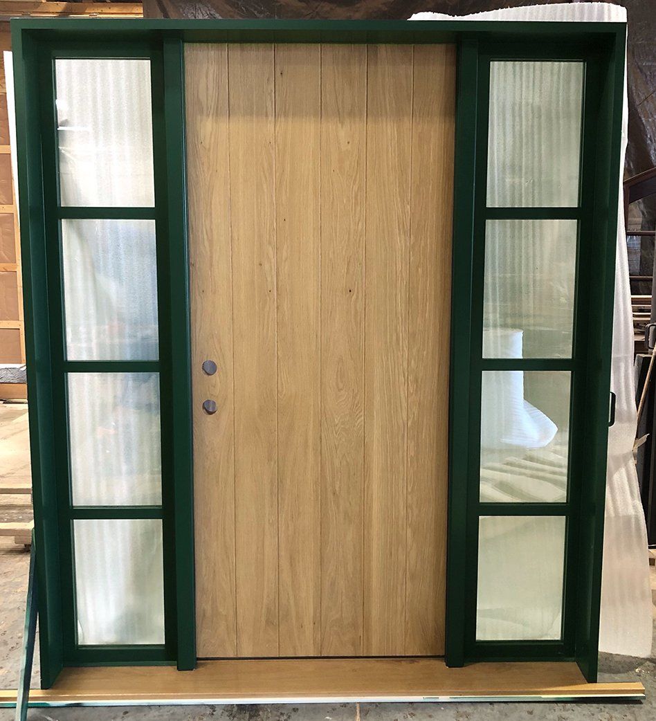 Solid white oak planked panel entry door with 5 lite sidelites factory finished