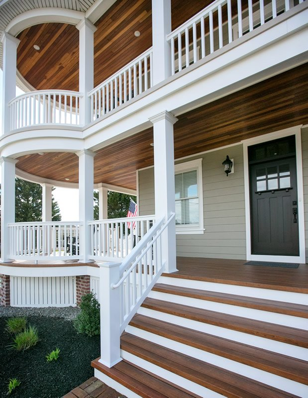 The front porch of a house with stairs leading up to it