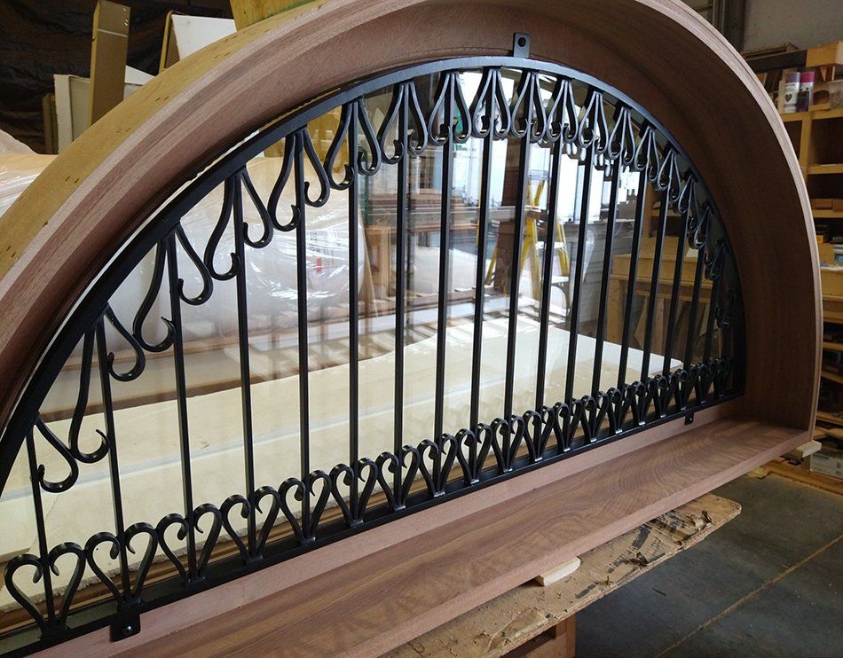 Custom metal grille work on half round transom