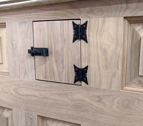 A wooden door with a butterfly hinge on it