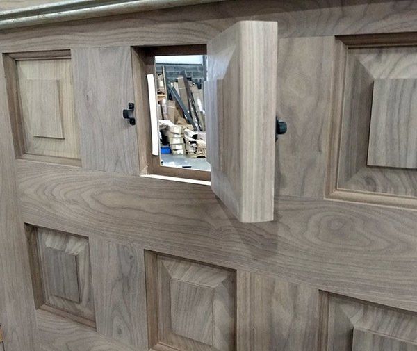 A wooden door with a window in the middle of it.