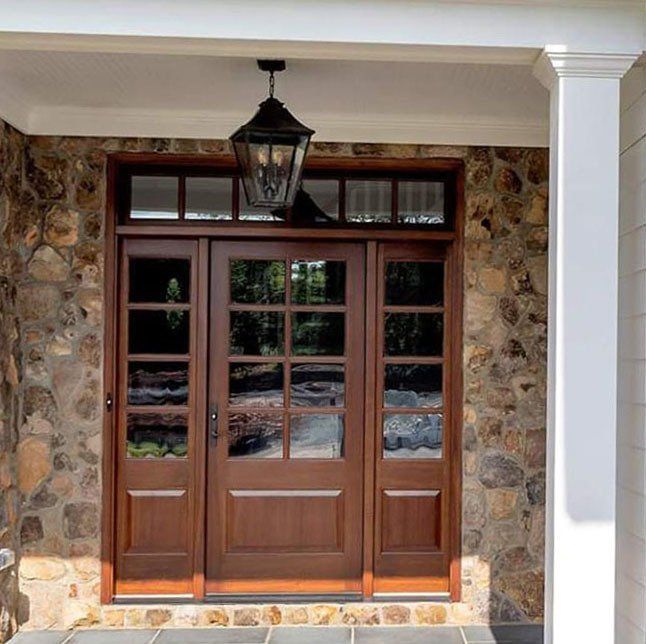 Custom 8 lite mahogany door with sidelights and transom for Craig Builders.