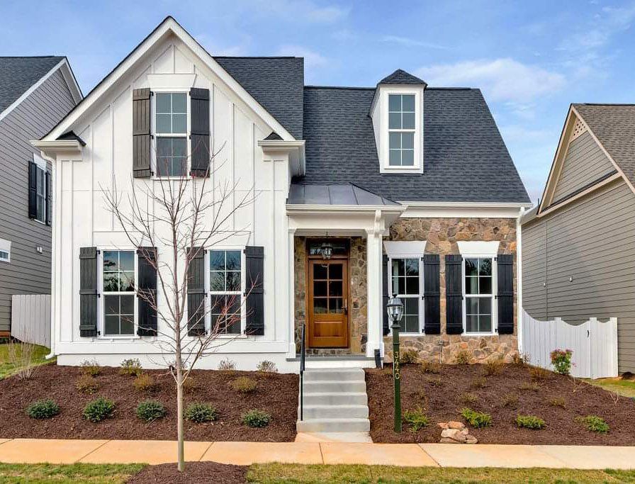 A white house with a black roof and black shutters