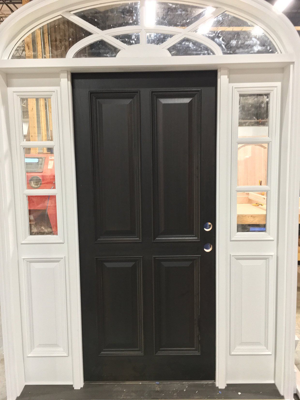 A black door with white trim and windows