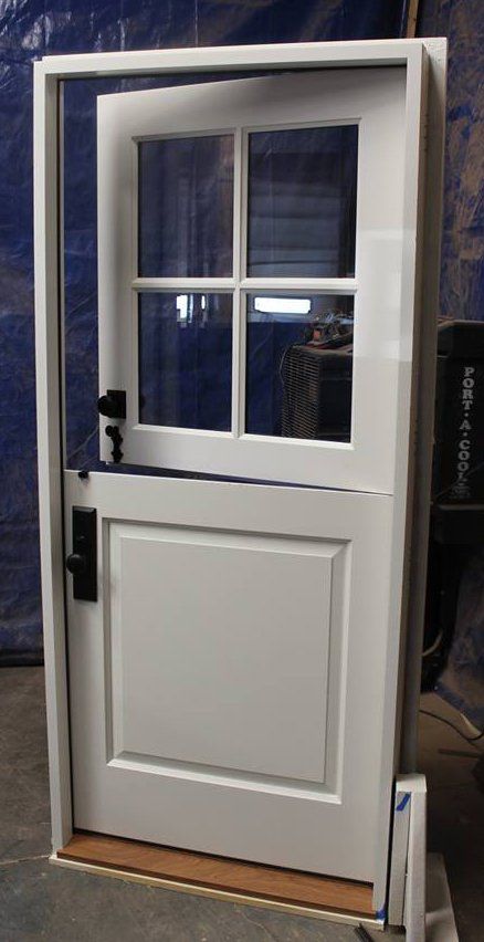 4 Lite exterior Dutch door with two color paint job. Blue on one side and white on the other.