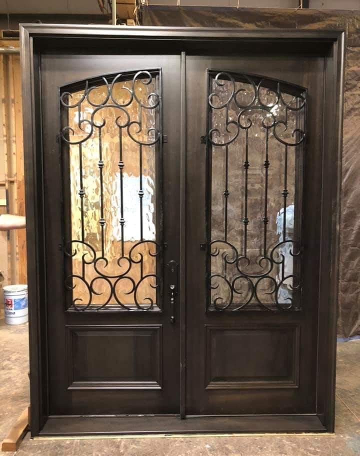Mahogany double door with wrought iron grilles