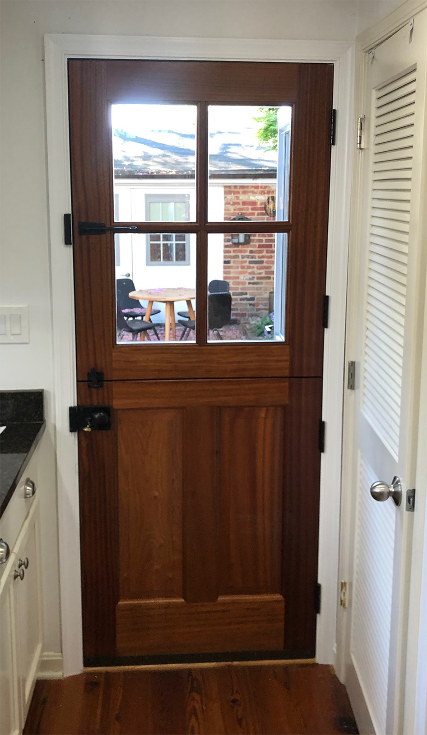 A wooden door with a glass window in a kitchen.