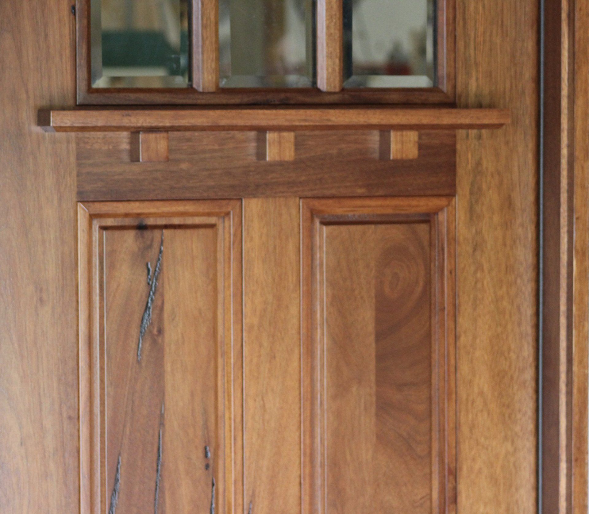 A close up of a wooden door with a window