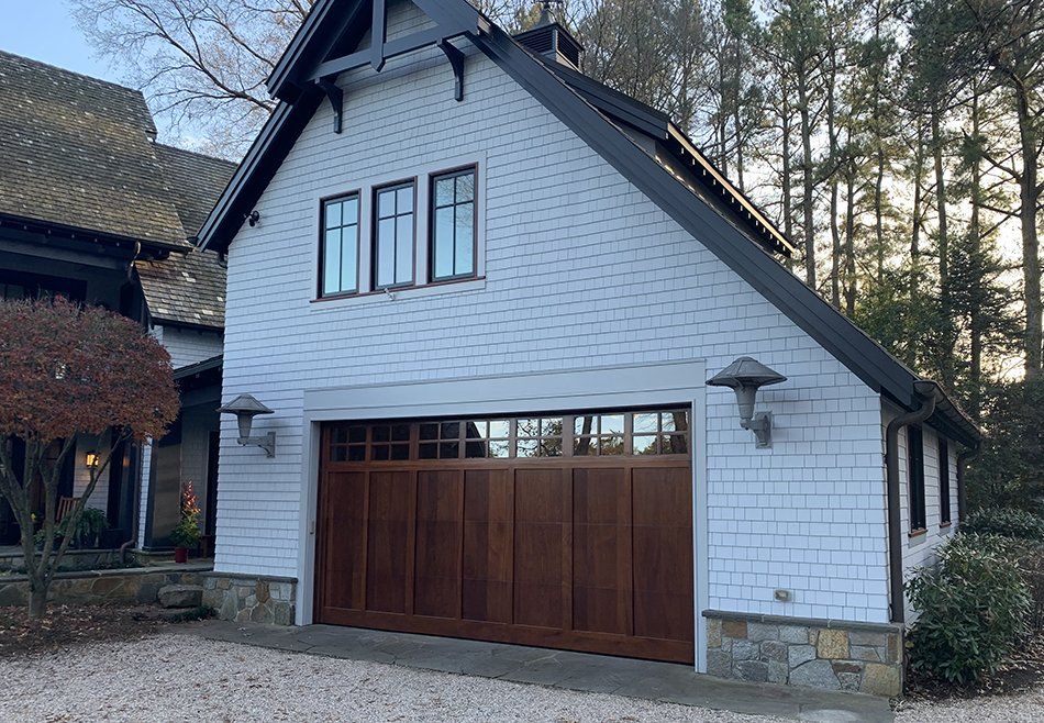 A white house with a large wooden garage door.