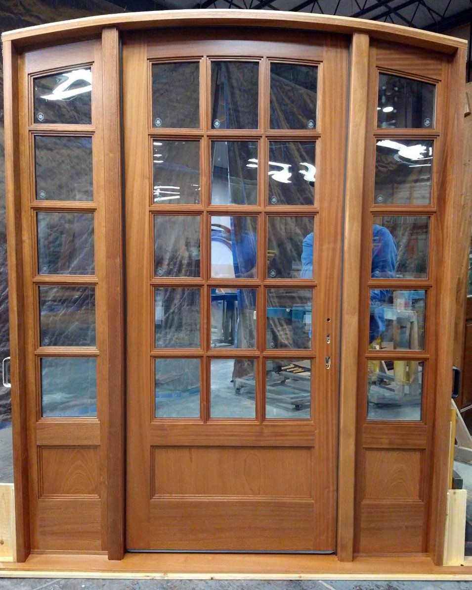 A large wooden door with a lot of windows