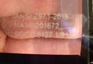 A close up of a person 's face with ansi 297.1-2015 written on it