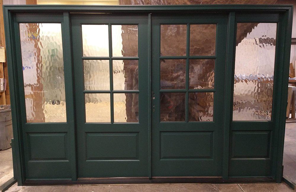 Mahogany double door unit with wide sidelights, Flemish glass Painted green