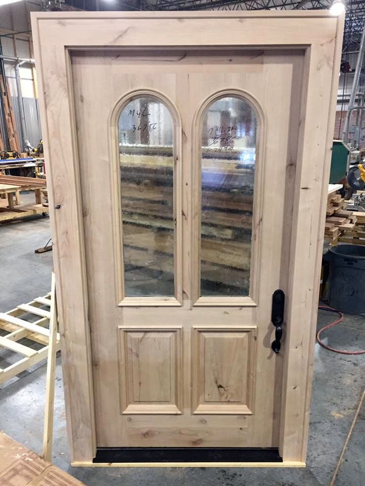 Traditional style exterior door with two rounded towers of glass