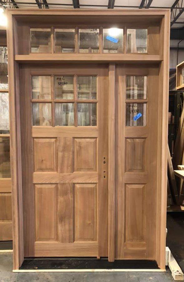 A wooden door is being built in a factory.